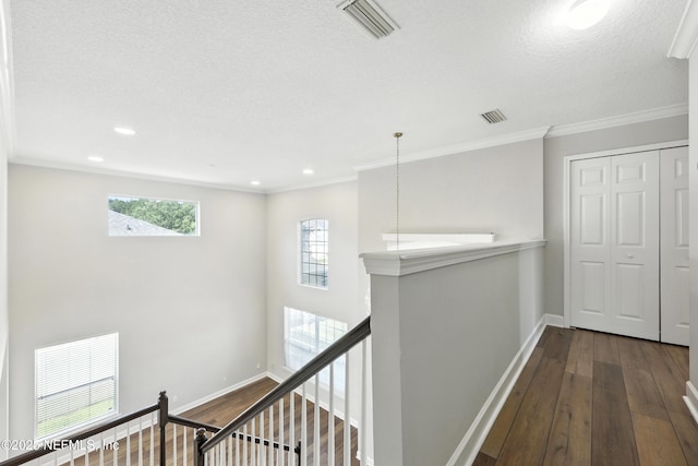 12490 Tropic Dr, Jacksonville, FL 32225 - hallway featuring an upstairs landing, dark wood-style floors, a textured ceiling, crown molding, and recessed lighting