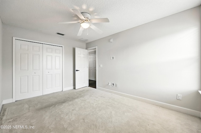 12490 Tropic Dr, Jacksonville, FL 32225 - unfurnished bedroom featuring carpet floors, a closet, a ceiling fan, and a textured ceiling