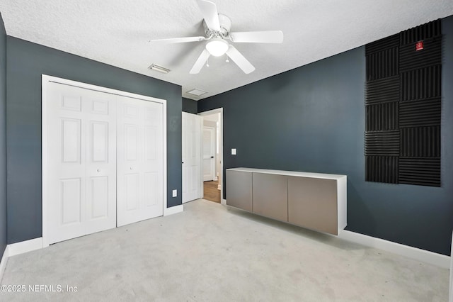 12490 Tropic Dr, Jacksonville, FL 32225 - unfurnished bedroom with a closet, carpet, a textured ceiling, and ceiling fan