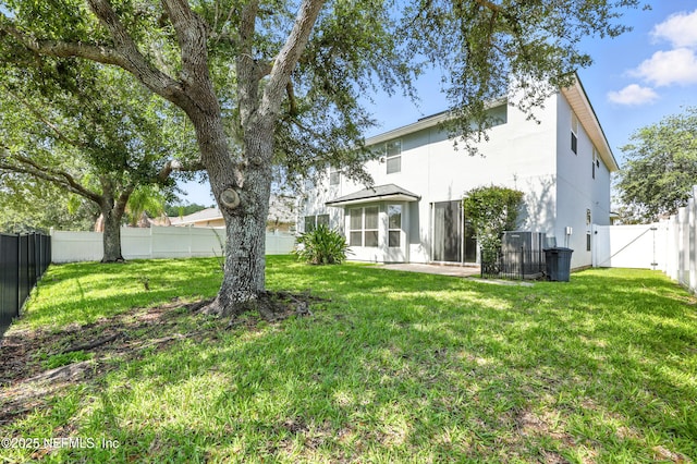 12490 Tropic Dr, Jacksonville, FL 32225 - rear view of property featuring stucco siding, a fenced backyard, a sunroom, and a gate