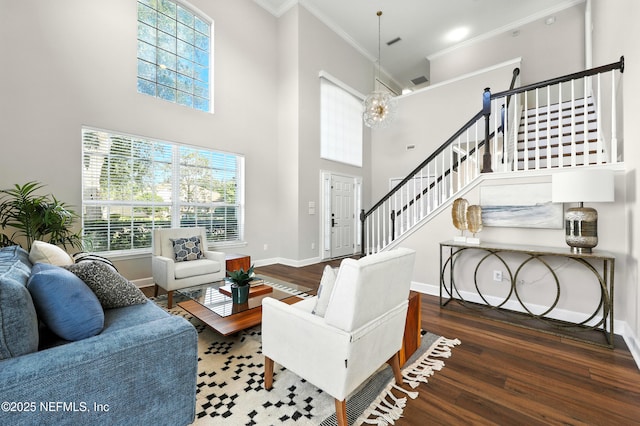 12490 Tropic Dr, Jacksonville, FL 32225 - living area with crown molding, wood finished floors, a chandelier, a high ceiling, and stairs