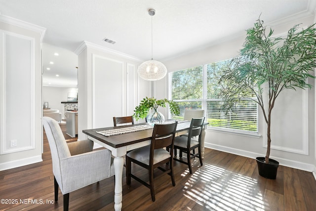 12490 Tropic Dr, Jacksonville, FL 32225 - dining room featuring dark wood-style floors, ornamental molding, recessed lighting, and a chandelier