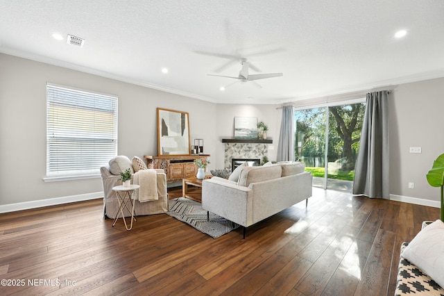 12490 Tropic Dr, Jacksonville, FL 32225 - living area with ceiling fan, dark wood-type flooring, ornamental molding, a fireplace, and recessed lighting