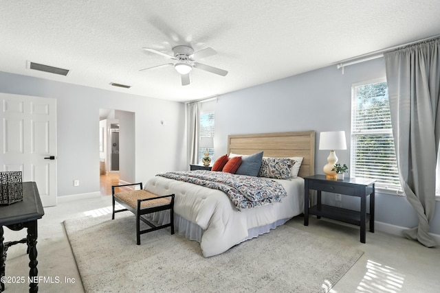 12490 Tropic Dr, Jacksonville, FL 32225 - bedroom with light carpet, a textured ceiling, ceiling fan, and connected bathroom