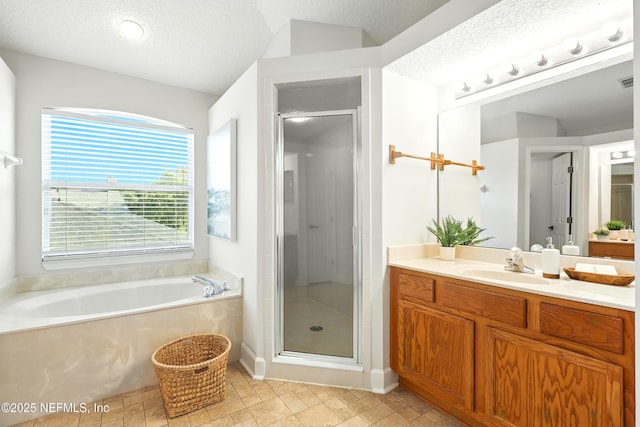 12490 Tropic Dr, Jacksonville, FL 32225 - full bath with vanity, a stall shower, a bath, and a textured ceiling