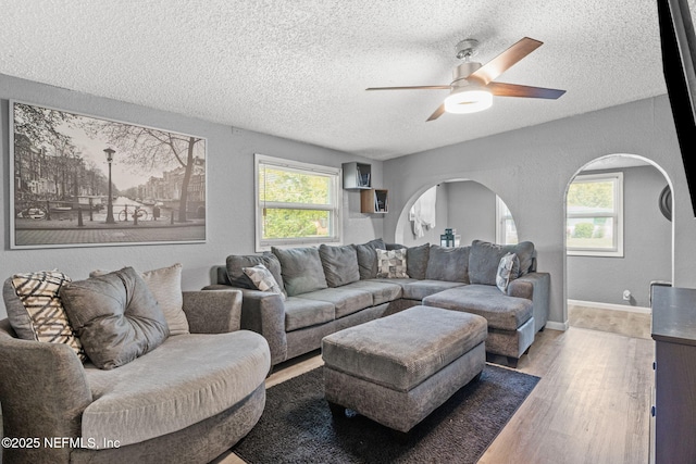 5414 Cleveland Rd, Jacksonville, FL 32209 - living room featuring a textured ceiling, arched walkways, wood finished floors, and ceiling fan