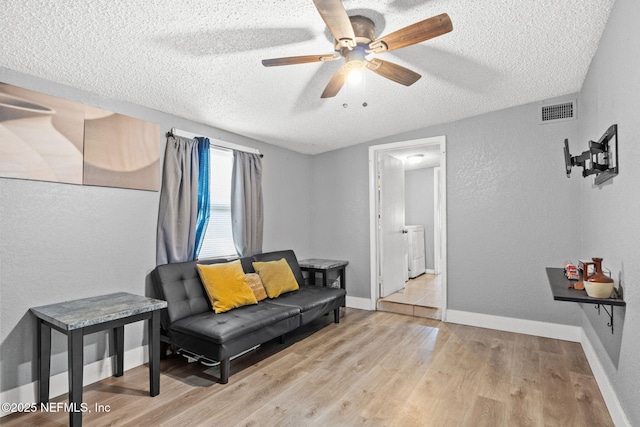 5414 Cleveland Rd, Jacksonville, FL 32209 - sitting room featuring a textured ceiling, a textured wall, wood finished floors, ceiling fan, and washer / dryer