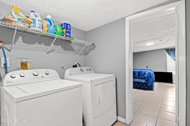 5414 Cleveland Rd, Jacksonville, FL 32209 - washroom with a textured ceiling, washing machine and clothes dryer, light tile patterned floors, and a textured wall