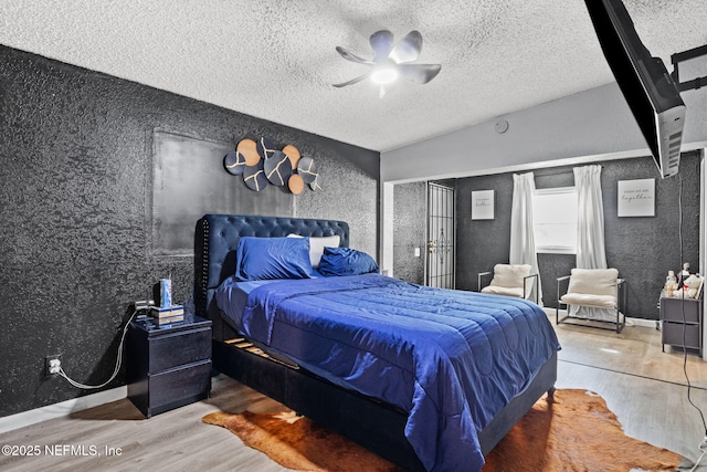 5414 Cleveland Rd, Jacksonville, FL 32209 - bedroom featuring wood finished floors, a textured ceiling, a textured wall, and ceiling fan