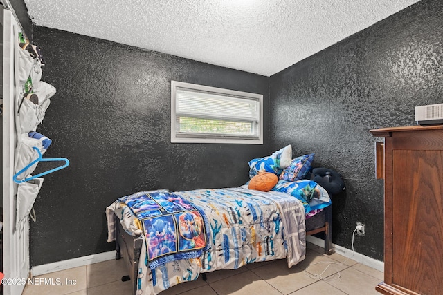 5414 Cleveland Rd, Jacksonville, FL 32209 - tiled bedroom featuring a textured ceiling and baseboards