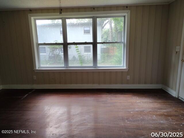 7228 Zona Ave, Jacksonville, FL 32211 - spare room featuring dark wood finished floors, healthy amount of natural light, and wood walls