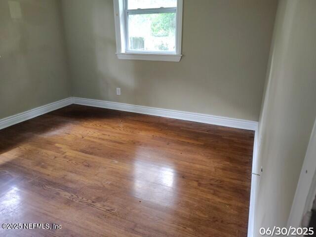 7228 Zona Ave, Jacksonville, FL 32211 - unfurnished room with baseboards and dark wood-type flooring