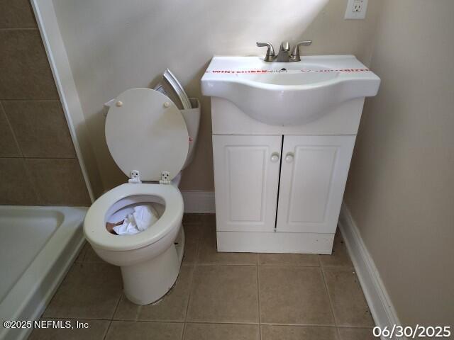 7228 Zona Ave, Jacksonville, FL 32211 - bathroom with tile patterned flooring, tiled shower, and vanity