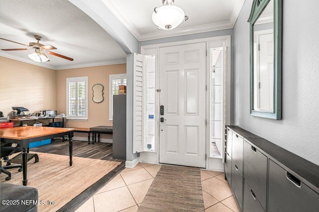 11598 Wynnfield Lakes Cir, Jacksonville, FL 32246 - foyer with a ceiling fan, light tile patterned floors, crown molding, and arched walkways