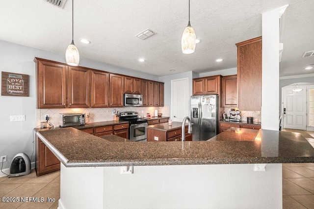 11598 Wynnfield Lakes Cir, Jacksonville, FL 32246 - kitchen featuring stainless steel appliances, a spacious island, light tile patterned floors, decorative backsplash, and a kitchen bar