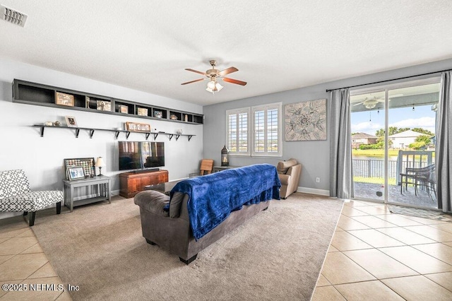 11598 Wynnfield Lakes Cir, Jacksonville, FL 32246 - living area featuring light tile patterned floors, ceiling fan, and a textured ceiling