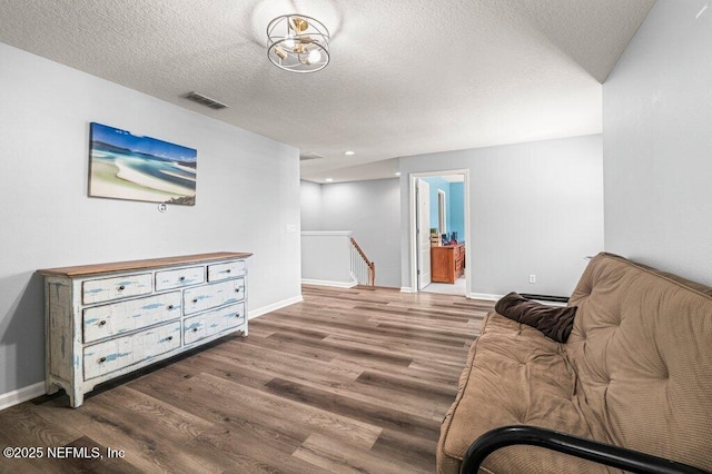 11598 Wynnfield Lakes Cir, Jacksonville, FL 32246 - living area featuring an upstairs landing, wood finished floors, and a textured ceiling