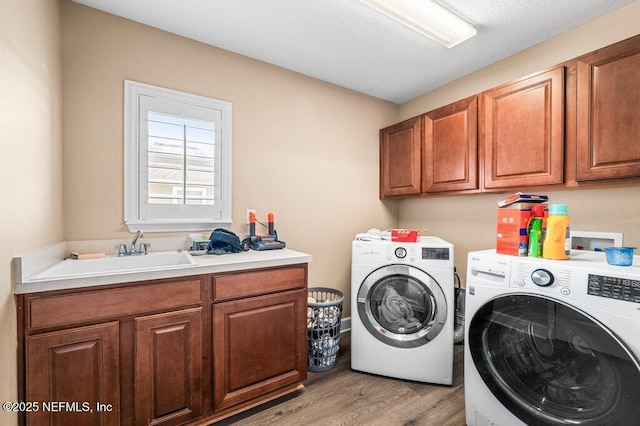 11598 Wynnfield Lakes Cir, Jacksonville, FL 32246 - washroom with washer and dryer, cabinet space, and light wood-style flooring