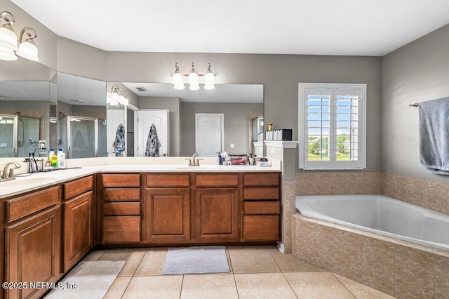 11598 Wynnfield Lakes Cir, Jacksonville, FL 32246 - bathroom with a shower stall, double vanity, a garden tub, and tile patterned flooring