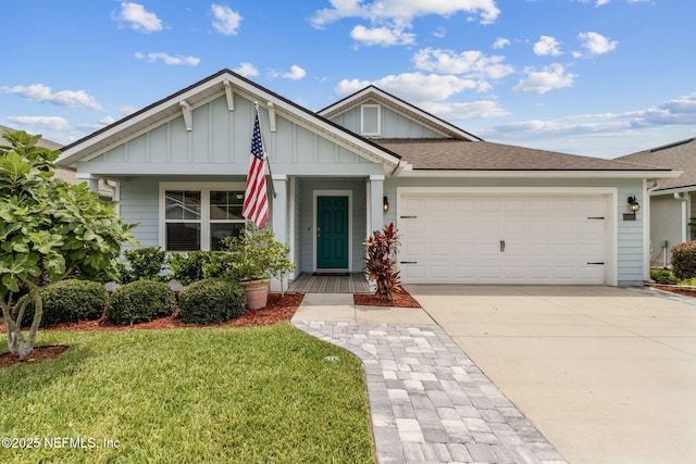 83687 Nether St, Fernandina Beach, FL 32034 - view of front of property with board and batten siding, a garage, driveway, a front lawn, and a shingled roof