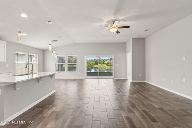 83687 Nether St, Fernandina Beach, FL 32034 - unfurnished living room with plenty of natural light, dark wood finished floors, lofted ceiling, ceiling fan, and recessed lighting