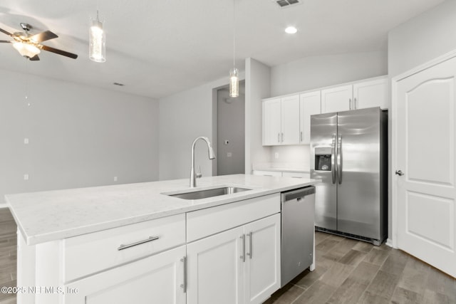 83687 Nether St, Fernandina Beach, FL 32034 - kitchen featuring stainless steel appliances, a ceiling fan, wood finished floors, pendant lighting, and a center island with sink