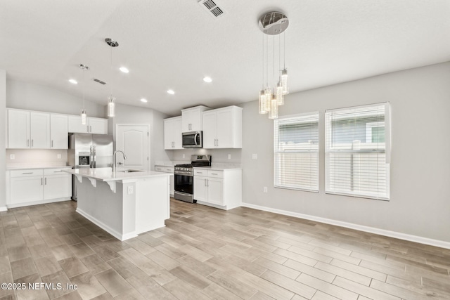 83687 Nether St, Fernandina Beach, FL 32034 - kitchen with appliances with stainless steel finishes, light countertops, light wood-style floors, recessed lighting, and white cabinetry