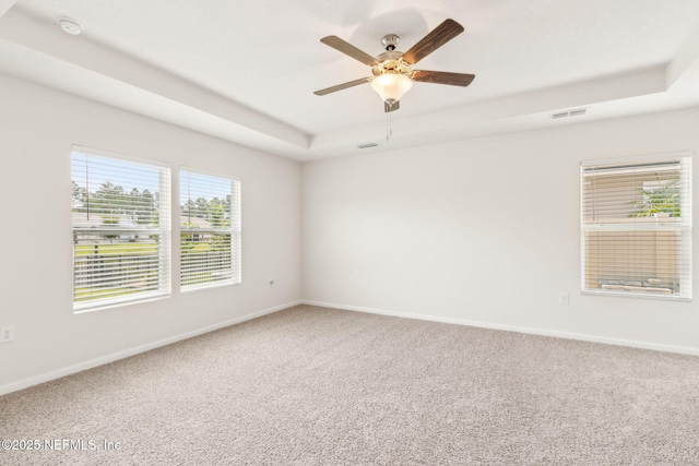 83687 Nether St, Fernandina Beach, FL 32034 - empty room featuring a raised ceiling, carpet, ceiling fan, and a smoke detector