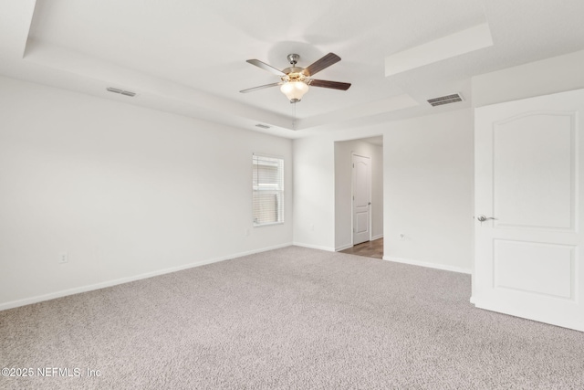 83687 Nether St, Fernandina Beach, FL 32034 - unfurnished bedroom with a raised ceiling, carpet flooring, and a ceiling fan