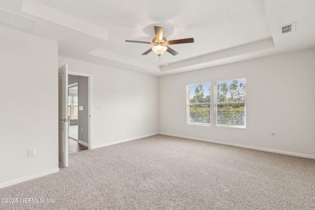 83687 Nether St, Fernandina Beach, FL 32034 - spare room featuring a tray ceiling, carpet flooring, and ceiling fan