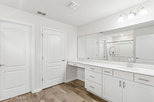 83687 Nether St, Fernandina Beach, FL 32034 - bathroom with vanity, a stall shower, and wood finished floors