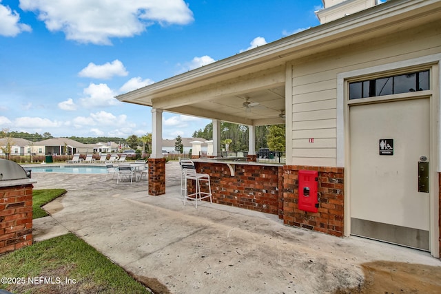 83687 Nether St, Fernandina Beach, FL 32034 - view of patio / terrace featuring exterior bar, a ceiling fan, and a community pool