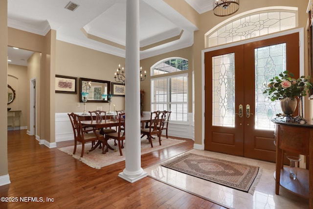 1521 Nottingham Knoll Dr, Jacksonville, FL 32225 - foyer entrance featuring french doors, wood-type flooring, decorative columns, ornamental molding, and a chandelier