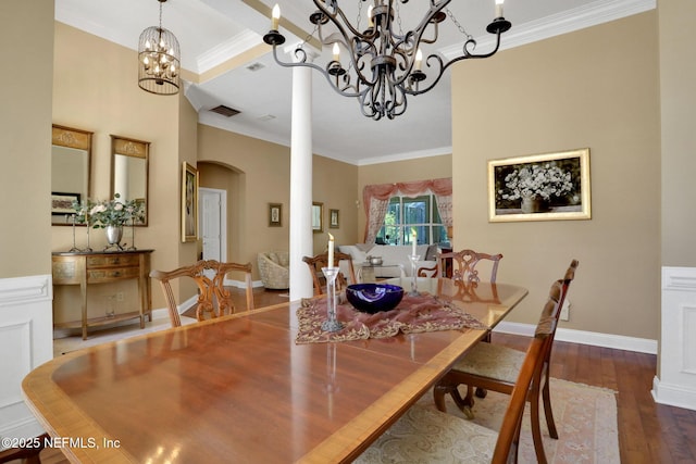 1521 Nottingham Knoll Dr, Jacksonville, FL 32225 - dining space with crown molding, a chandelier, arched walkways, and wood finished floors