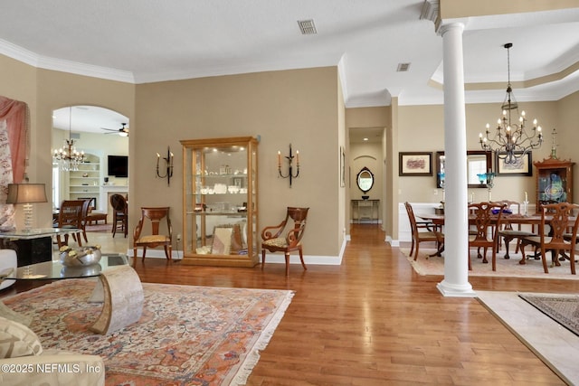 1521 Nottingham Knoll Dr, Jacksonville, FL 32225 - living room with a chandelier, wood finished floors, ornamental molding, decorative columns, and a ceiling fan