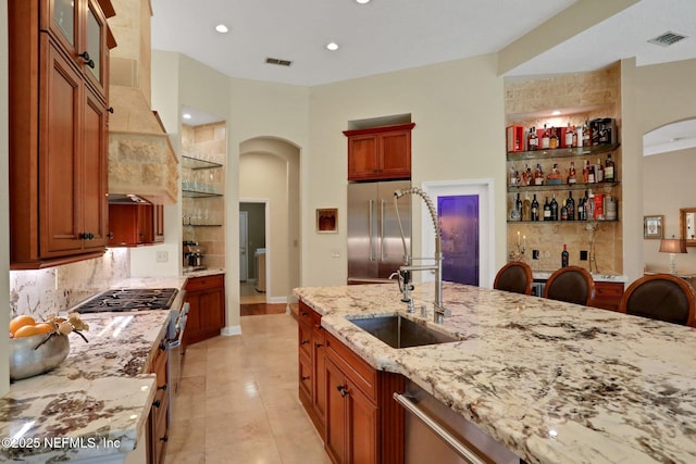 1521 Nottingham Knoll Dr, Jacksonville, FL 32225 - kitchen with appliances with stainless steel finishes, arched walkways, backsplash, light stone countertops, and recessed lighting