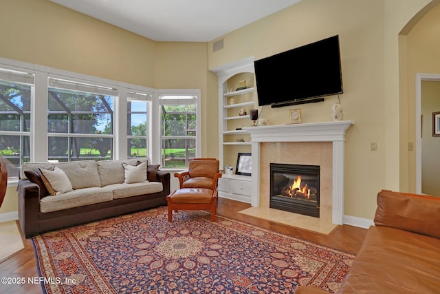1521 Nottingham Knoll Dr, Jacksonville, FL 32225 - living room with wood finished floors, a premium fireplace, built in features, and arched walkways