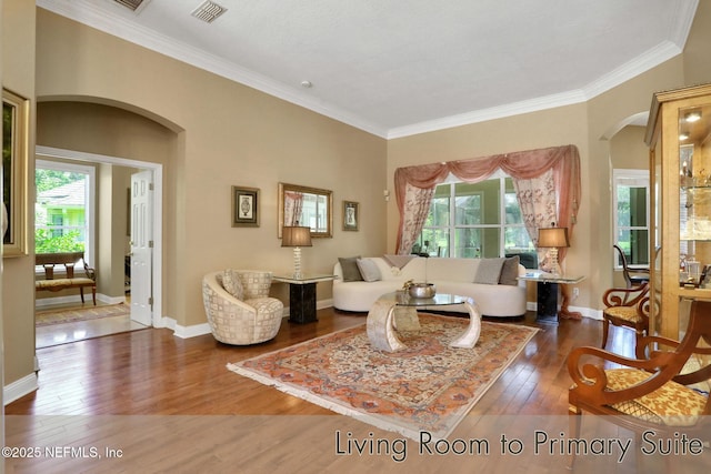 1521 Nottingham Knoll Dr, Jacksonville, FL 32225 - living room featuring arched walkways, wood-type flooring, and crown molding