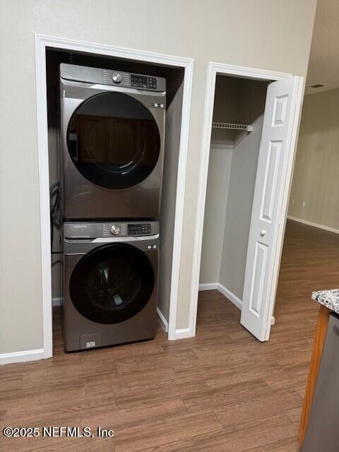 9556 Armelle Way Unit 2, Jacksonville, FL 32257 - laundry room with stacked washer / dryer and wood finished floors