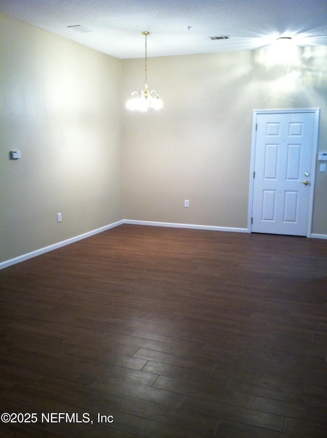 9556 Armelle Way Unit 2, Jacksonville, FL 32257 - empty room featuring a chandelier and dark wood finished floors