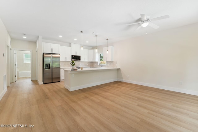 981 Butler Ave, Saint Augustine, FL 32084 - kitchen with appliances with stainless steel finishes, a peninsula, light countertops, recessed lighting, and light wood-style floors
