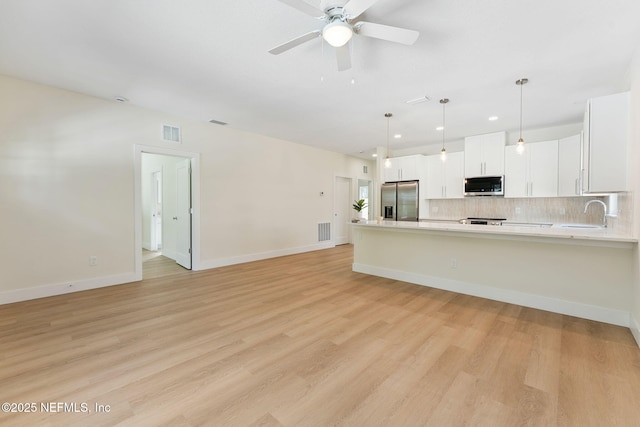 981 Butler Ave, Saint Augustine, FL 32084 - kitchen with appliances with stainless steel finishes, light countertops, tasteful backsplash, a ceiling fan, and a peninsula