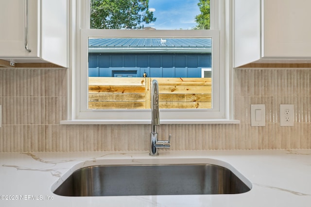 981 Butler Ave, Saint Augustine, FL 32084 - kitchen view of white cabinets, tasteful backsplash, and light stone countertops