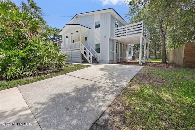 631-633 Main St, Atlantic Beach, FL 32233 - coastal inspired home featuring driveway, stairs, and a porch