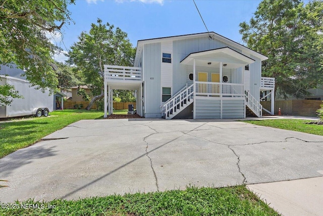 631-633 Main St, Atlantic Beach, FL 32233 - view of front of home featuring stairway, a porch, and a front lawn