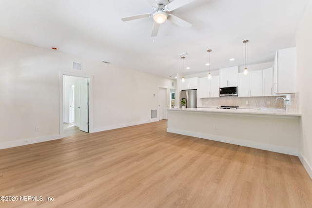 989 Butler Ave, Saint Augustine, FL 32084 - unfurnished living room featuring light wood finished floors, ceiling fan, and recessed lighting