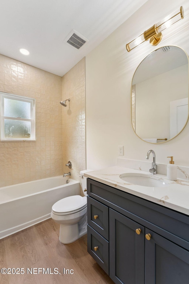 989 Butler Ave, Saint Augustine, FL 32084 - bathroom featuring wood finished floors, vanity, and washtub / shower combination