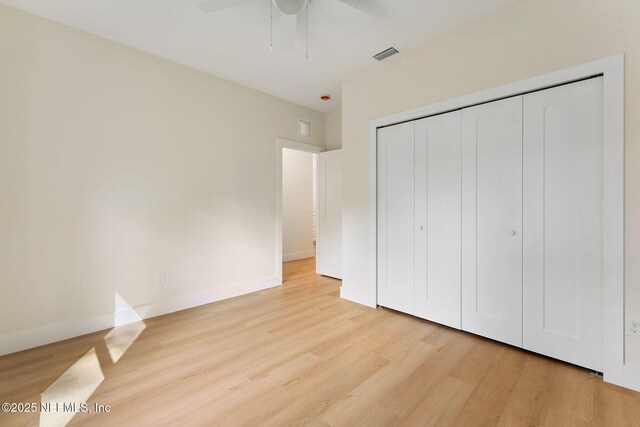 989 Butler Ave, Saint Augustine, FL 32084 - unfurnished bedroom with light wood finished floors, a closet, and a ceiling fan