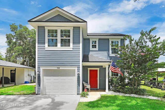 724 N Pine Ave, Green Cove Springs, FL 32043 - view of front of home featuring an attached garage, concrete driveway, a shingled roof, and a front lawn