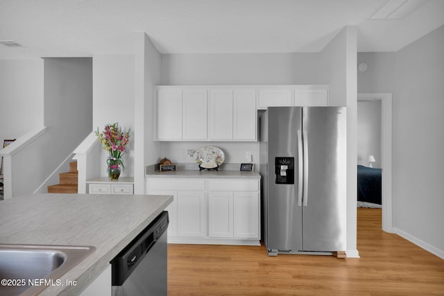 724 N Pine Ave, Green Cove Springs, FL 32043 - kitchen featuring appliances with stainless steel finishes, light wood finished floors, white cabinetry, and light countertops
